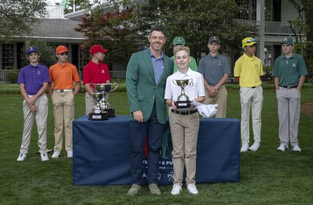 Rory McIlroy pictured with some of the Drive, Chip & Putt competitors at Augusta National on Sunday
