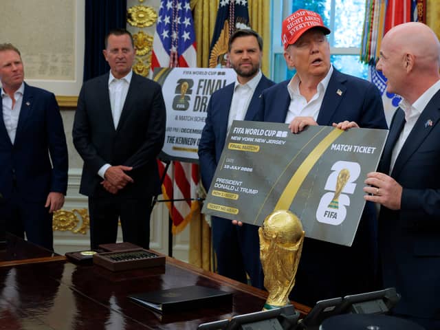 U.S. President Donald Trump is presented a novelty ticket by FIFA President Gianni Infantino during an announcement about the 2026 World Cup with Vice President JD Vance and Special Envoy Richard Grenell and White House FIFA 2026 Task Force Executive Director Andrew Giuliani in the Oval Office at the White House on August 22, 2025 in Washington, DC.  (Photo by Chip Somodevilla/Getty Images)