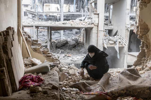 A woman sifts through rubble in her house in the Beryanak district of Tehran after it was damaged amid the ongoing Iran War (Picture: Majid Saeedi)