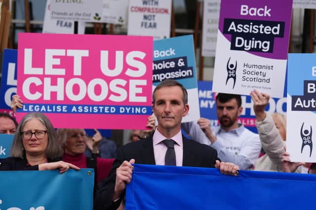 Liberal Democrat MSP Liam McArthur pictured alongside assisted dying campaigners last year