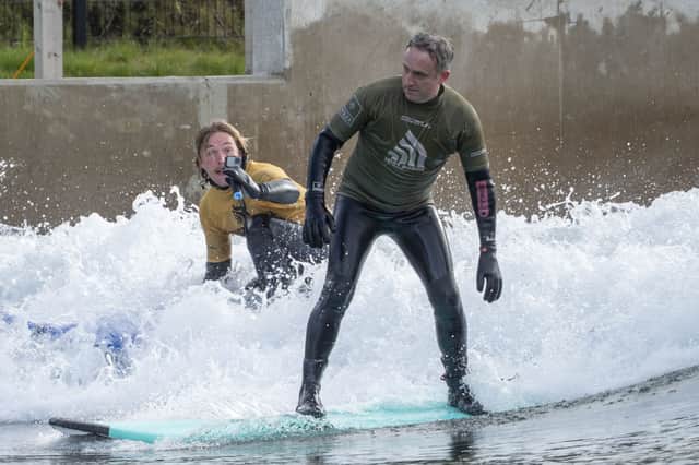 Scottish Liberal Democrat leader Alex Cole-Hamilton rides the waves at the Lost Shore surf resort near Edinburgh