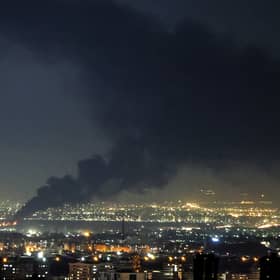 Thick black smoke billows into the sky after a missile strike on Iranian capital Tehran on Tuesday (Picture: Atta Kenare)