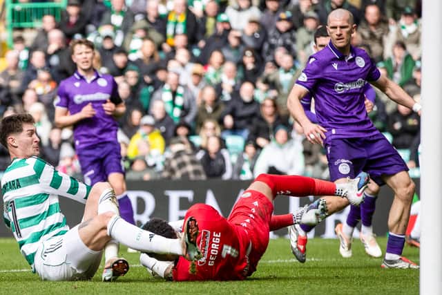 Celtic's Tomas Cvancara (L) collides with St Mirren goalkeeper Shamal George at Parkhead.