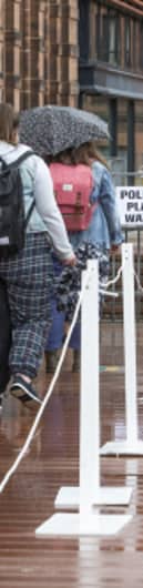 People queue to vote in the 2021 Scottish Parliament election outside the polling station at Notre Dame Primary School in Glasgow