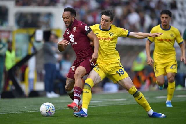 Enzo Ebosse of Torino FC challenged by Kieron Bowie of Hellas Verona during the Serie A match at Stadio Olimpico di Torino.