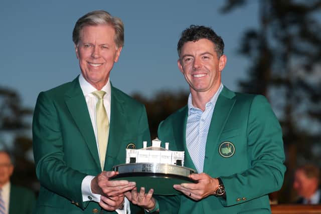 Having already given him his second Green Jacket, Augusta National chairman Fred Ridley presents the Masters Tournament trophy to Rory McIlroy