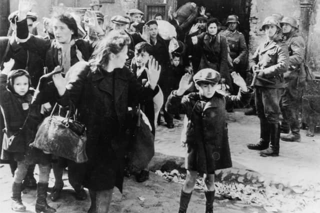 A group of Jewish civilians are held at gunpoint by German SS troops during the Warsaw Ghetto Uprising in German-occupied Poland in 1943 (Picture: Keystone/Hulton Archive)