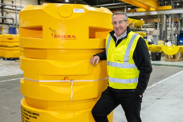 Gary Yeoman, sales director, standing next to a yellow "buoyancy module"