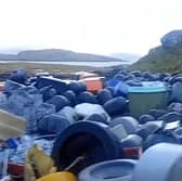 Piles of fish farm waste in a bay at Earshader on the Isle of Lewis 