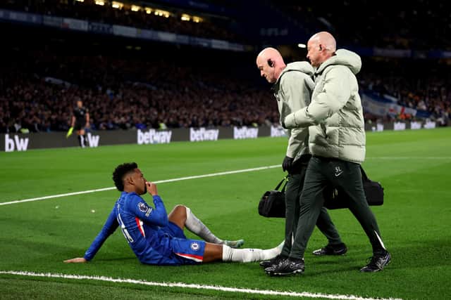 Estevao of Chelsea reacts with an injury during the Premier League match between Chelsea and Manchester United at Stamford Bridge.