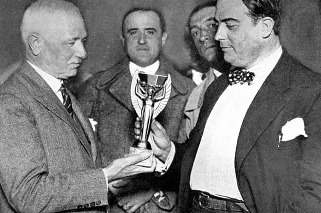 Frenchman Jules Rimet (left), head of FIFA, hands over the World Cup trophy to Dr Raul Jude, president of the Uruguayan football association on July 5, 1930 in Montevideo. (Photo by OFF / AFP via Getty Images)