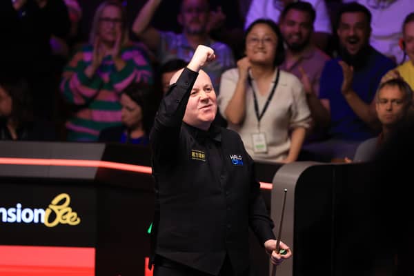 John Higgins celebrates winning his match against Ronnie O'Sullivan on day ten of the Halo World Snooker Championship 2026 at the Crucible Theatre, Sheffield. 