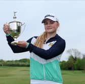 Carly McDonald shows off the trophy after winning The R&A Girls U16s Championship at Gog Magog