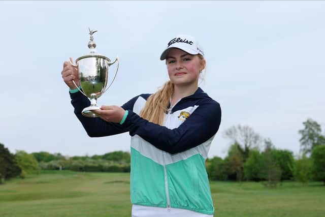 Carly McDonald shows off the trophy after winning The R&A Girls U16s Championship at Gog Magog