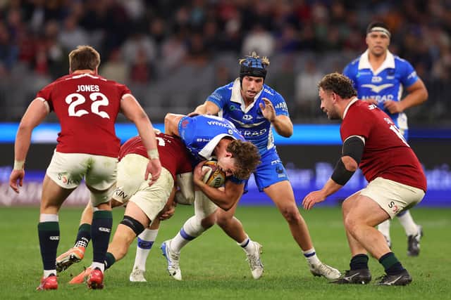 Bayley Kuenzle, with ball, plays against Huw Jones, right, as Western Force face the British & Irish Lions at Optus Stadium in Perth, Australia, on June 28, 2025.