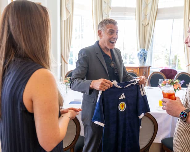 Clooney was presented with a Scotland football top by competition winner Claire Phale