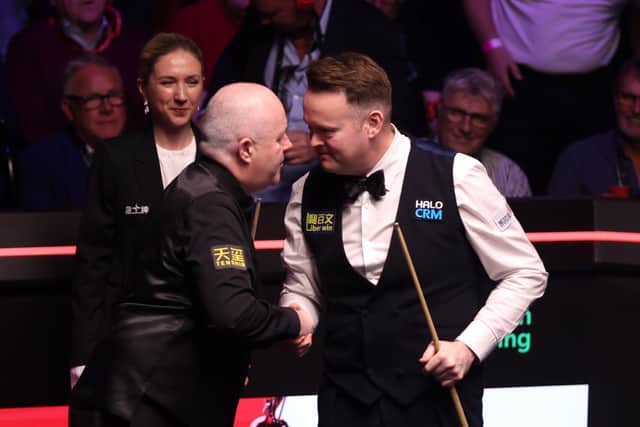 John Higgins, left, congratulates Shaun Murphy on his win at the Crucible.