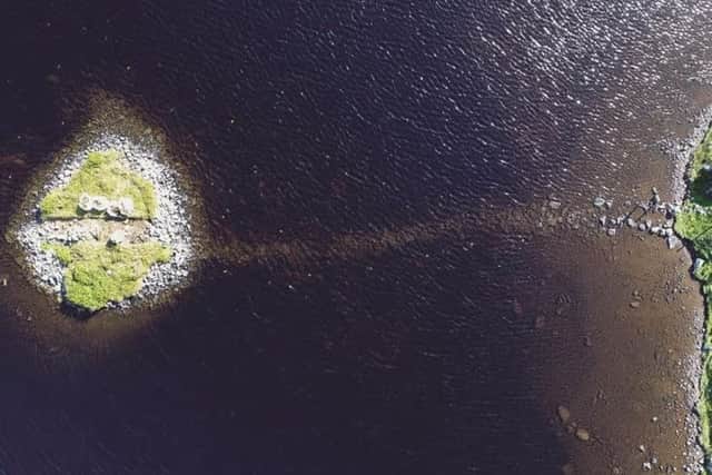 An aerial view of the crannog at Loch Bhorgastail, which shows the stone causeway leading to the site