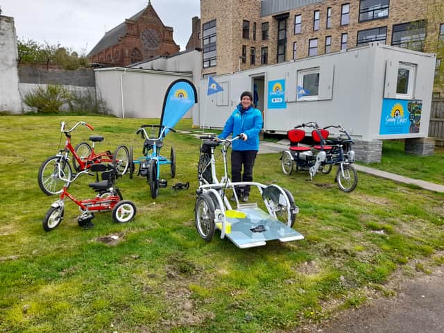 Sunny Cycles project coordinator Carol Thompson with various adapted bikes and trikes at its Glasgow Green base