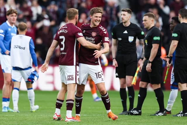 Kingsley celebrates the win over Rangers with his Hearts teammate Blair Spittal at Tynecastle.