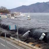 The devastating tsunami wave that hit Japan in March 2011, seen flowing into the city of Miyako in Iwate prefecture shortly after a 9.0 magnitude earthquake (Picture: Jiji Press)