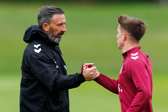 Derek McInnes, left, welcomes Hearts midfielder Cammy Devlin at training.