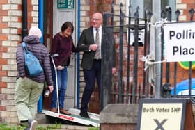 John Swinney and his wife Elizabeth exit a polling station