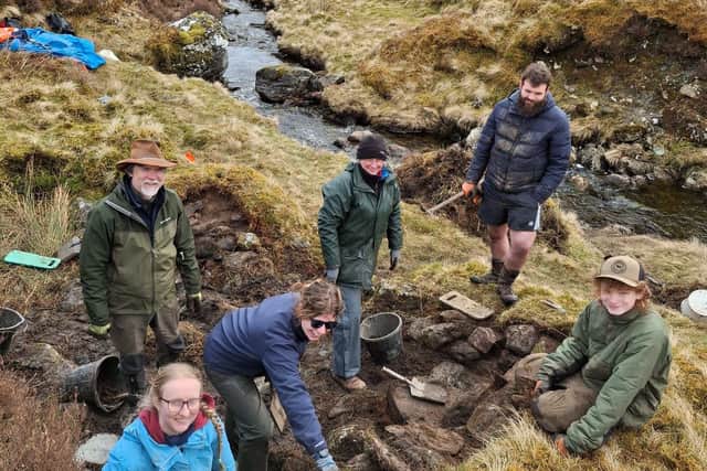 National Trust for Scotland archaeology team and volunteers at Ben Lawers NNR at whisky still site