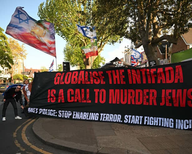 People hold a banner reading 'Globalise the Intifada is a call to murder Jews' at a protest in Golders Green, London, following the stabbing of two people in the area last month (Picture: Justin Tallis)