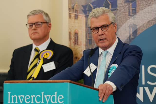 The newly elected SNP MSP for Inverclyde, Stuart McMillan, looks on as Reform UK's leader in Scotland, Malcolm Offord, speaks after the result  was declared at Greenock Town Hall (Picture: Peter Summers)