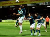 Motherwell’s Sam Nicholson, top, jumps for a header with Celtic's Auston Trusty before a penalty was awarded via a VAR review