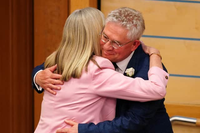 Former presiding officer Alison Johnstone hands over the chair to Kenny Gibson