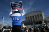 A protest outside the US Supreme Court earlier this year as the justices heard arguments about transgender athletes in women's sports (Picture: Oliver Contreras)