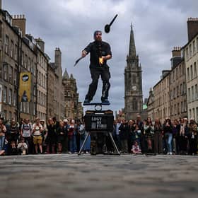 Street entertainers perform on Edinburgh's Royal Mile during the Edinburgh Festival Fringe.