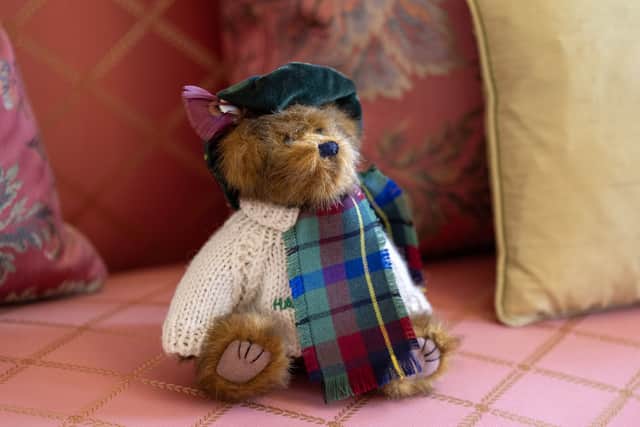 Haddington, a teddy bear that belonged to the late Queen Elizabeth II on the sofa in the Sitting Room at the Palace of Holyroodhouse.