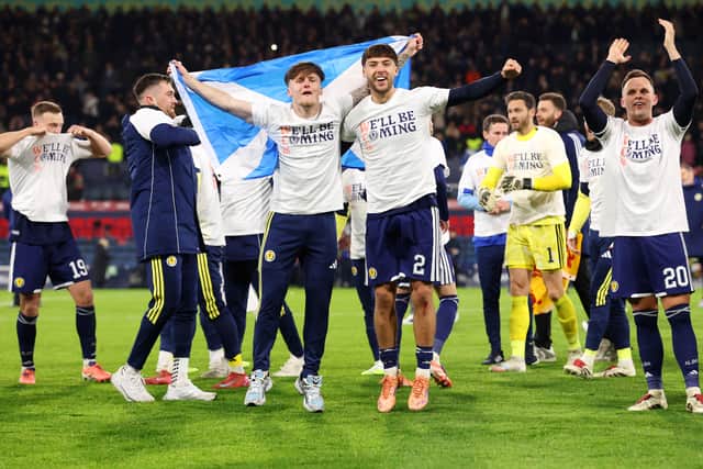 Aaron Hickey (R) of Scotland celebrates World Cup qualification alongside team-mate Ben Gannon-Doak