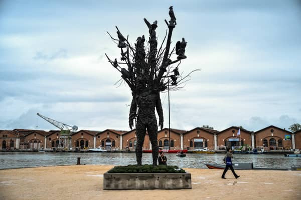 Visitors view Amalgam by US artist Nick Cave, during the pre-opening of the 61st Venice Biennale 
