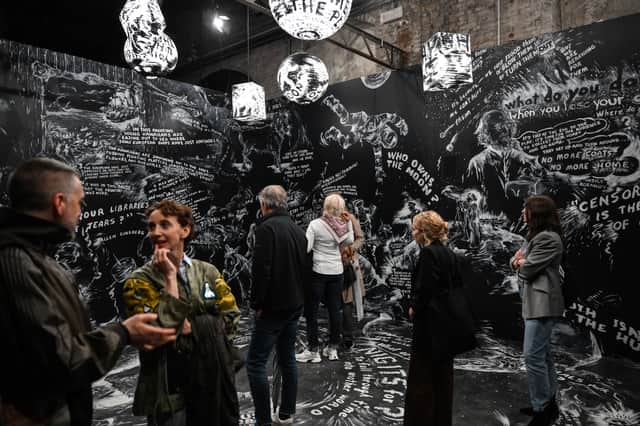 Visitors view Notebook by US artist Laurie Anderson, at the exhibition In Minor Keys at the 61st Venice Biennale
