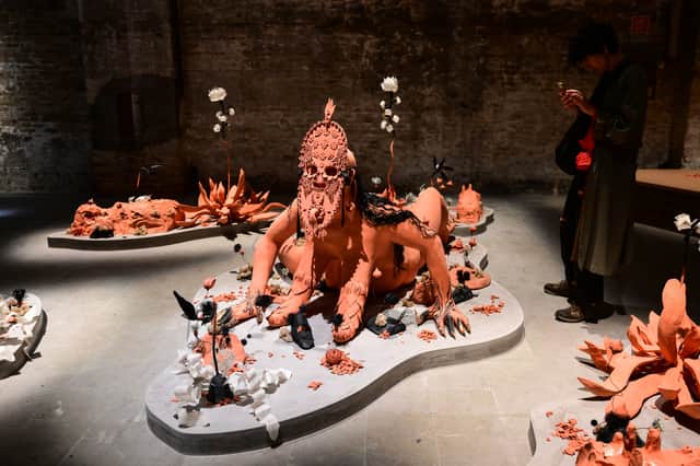 A visitor views Efflorescence/The Way We Wake by  Canadian artists Rajni Pereira + Marigold Santos at the exhibition In Minor Keys during the pre-opening of the 61st Venice Biennale