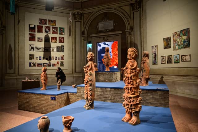 Visitors look at Untitled by Senegalese artist Seyni Awa Camara at the exhibition In Minor Keys during the pre-opening press view of the 61st Venice Biennale