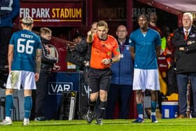 Referee John Beaton consults VAR and then awards Celtic a penalty after Motherwell's Sam Nicholson is judged to have handled the ball.  (Photo by Ross MacDonald / SNS Group)
