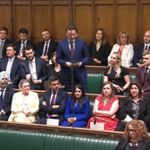 Gordon McKee (back row, second from left), Melanie Ward (back row, second from right) and Zubir Ahmed (from row, centre left) sat around Wes Streeting during his speech