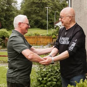 Taxi driver Brian Kelly (left) shaking hands with Prostate Cancer UK volunteer Tam Hewitt