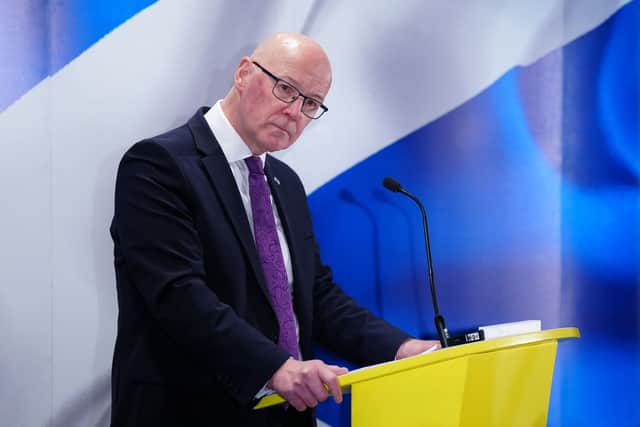 First Minister John Swinney speaking to journalists after Peter Murrell admitted embezzling SNP funds
