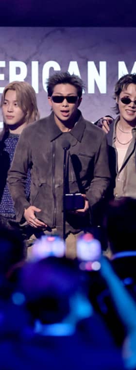 Jungkook, Jin, Jimin, RM, J-Hope, V and Suga of BTS accept the Artist of the Year award onstage during the 52nd American Music Awards.