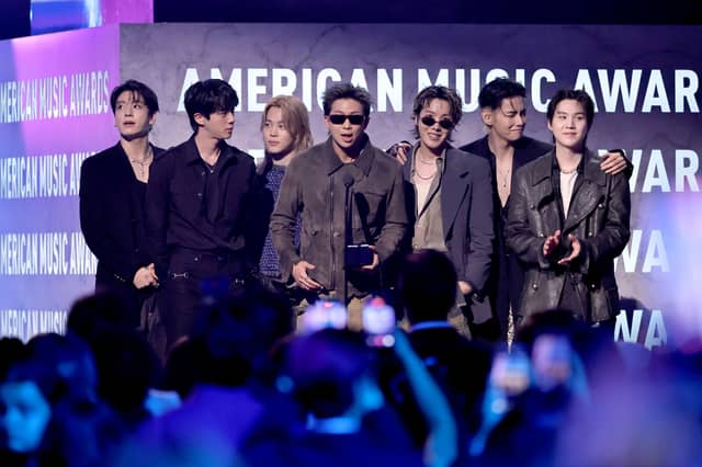 Jungkook, Jin, Jimin, RM, J-Hope, V and Suga of BTS accept the Artist of the Year award onstage during the 52nd American Music Awards.