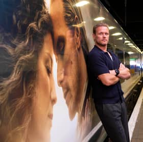 Sam Heughan unveils the Caledonian Sleeper's first full train wrap in London's Euston station, an Outlander-inspired design celebrating the series' connection to Scotland and economic benefit from tourism.