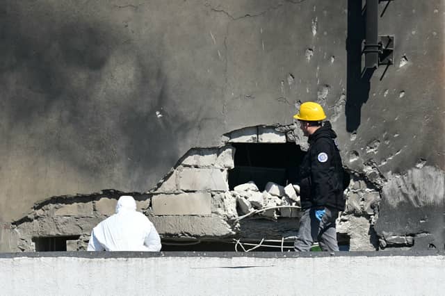 Police and forensic investigators examine the damage after a Russian drone hit a block of flats in Galati, eastern Romania (Picture: Daniel Mihailescu)