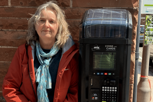 North Berwick resident Susan Hopkin beside a parking ticket machine in the town