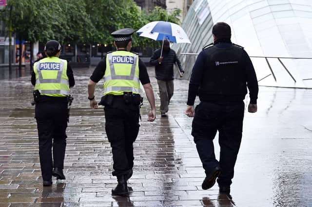 Police patrol St Enoch's Square in Glasgow following violent protests there in the wake of a knife attack in Belfast
